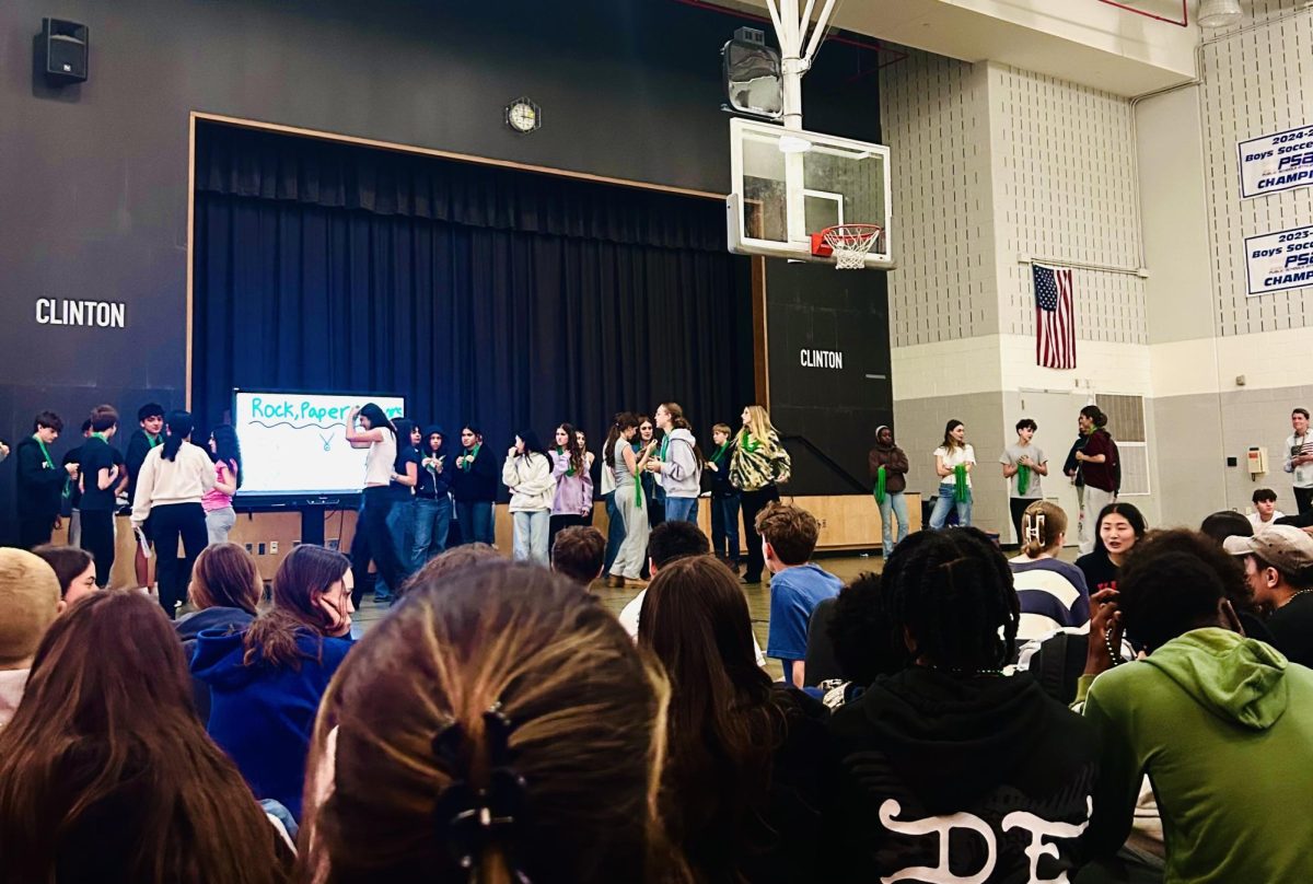 Clinton upper grades students gather in the gym to wrap up the rock paper scissors competition